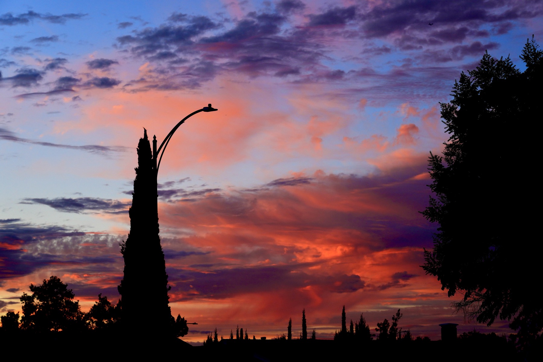 A very colorful sunset over suburban scene.