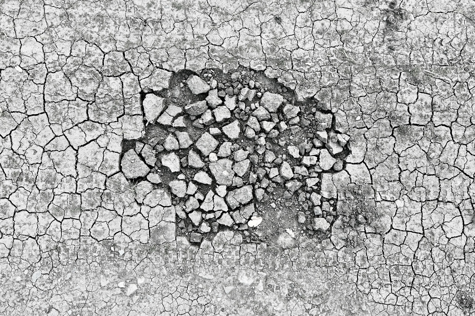 Dry earth cracks and a hole appears.