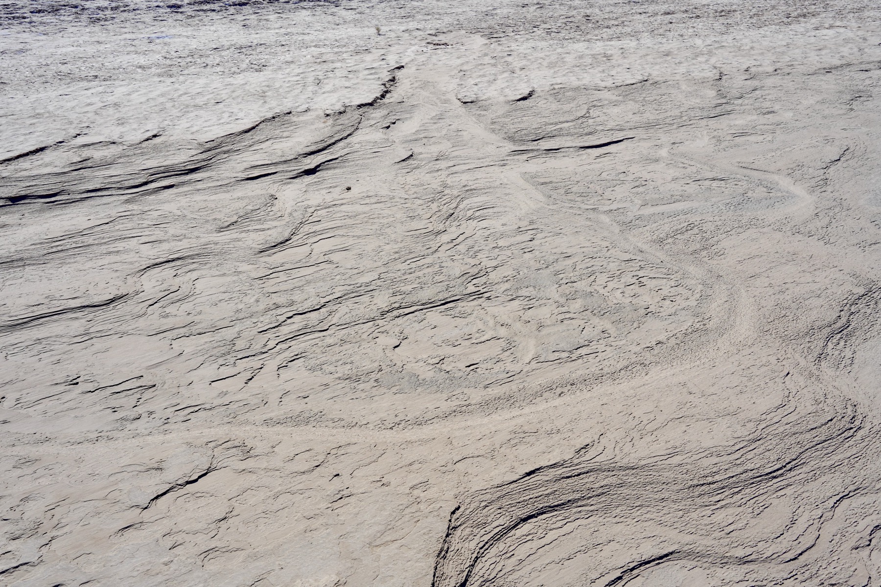 Dry and wind eroded mud flat of the Amargosa river in Death Valley.